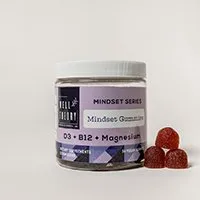 A jar labeled "Mindset Gummies" with D3, B12, Magnesium; three red supplements sit beside the jar.