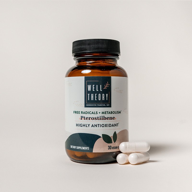 A brown "Well Theory Pterostilbene" supplement bottle with three white capsules on a plain background.