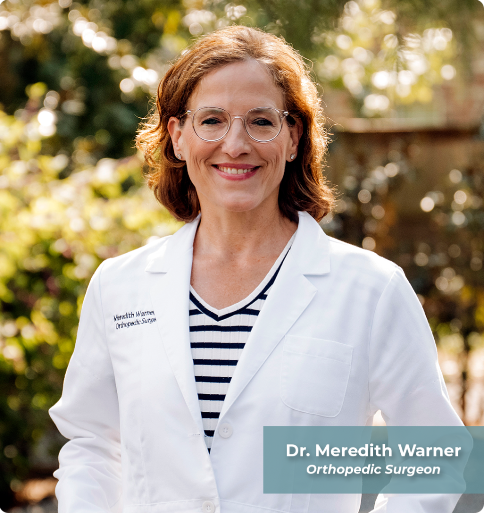 A smiling woman with brown hair and glasses in a white lab coat stands outdoors, promoting natural pain relief.